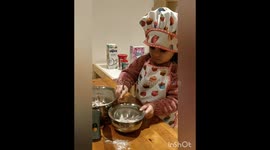 Little chef helping mum in making cupcakes