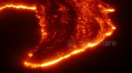 Lava emitted from Mount Etna illuminates the night sky in Sicily