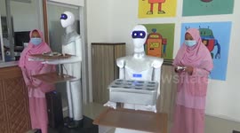 Female students in Indonesia create robot waiter to serve in canteen