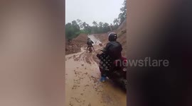 Locals battle through blocked roads after landslides in the Philippines