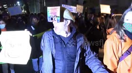 Crowds cheer protester on Westminster Bridge during London protest over policing bill