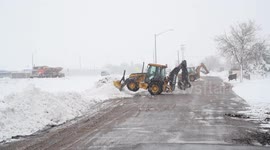 Backhoes working to clear huge amounts of snow from roads in western Nebraska