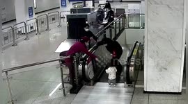 Chinese security guard hops over handrail to stop toddler from falling down escalator