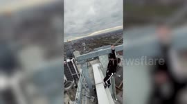 This stunning footage shows the moment a fitness fanatic decided to perform a set of pull ups ON TOP OF A SKYSCRAPER