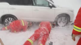 Chinese firefighters rescue vehicles and motorists trapped in heavy snowstorm