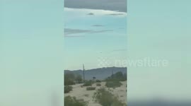 This crystal clear footage appears to show a UFO floating high above the Arizona desert in broad daylight