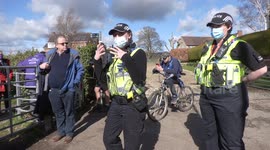 Police officers disperse racing fans on first day of Cheltenham Festival