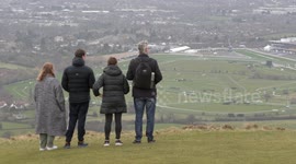 Fans ignore police warnings and take to hilltops to watch Cheltenham Races