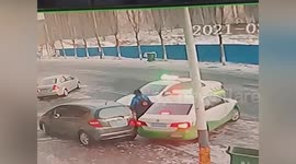 Car narrowly misses boy after sliding across road into vehicles in China