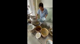 Vietnamese street chef demonstrates flying noodles that make many customers excited