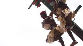 Terrifying Indian festival sees holy men hoisted 40 feet in air while carrying newborn babies