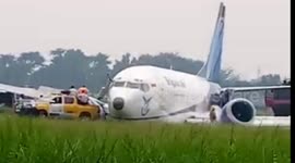 Dramatic moment Indonesian cargo plane slides off runway after landing gear collapses