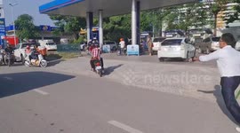Traffic officer whacks counterflowing motorcycle riders in Cambodia