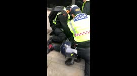 Police officer appears to punch London anti-lockdown protester during arrest