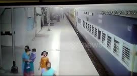 Moment woman cop saves couple from slipping under train in India