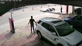 Scooter rider knocked over after utility pole collapses onto road in China