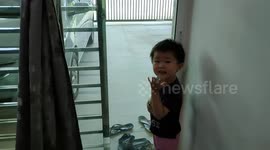 Funny toddler runs out to watch garbage truck collecting rubbishes