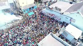 A youth climbs the top of greasy pole climbing competition held in southern India and won the prize