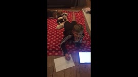Puppies using my son leg as a headrest whilst he tries to do his homework