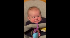 Baby has hilarious expression while grandma plays on the violin