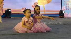 Audience in hysterics as little girl falls asleep during dance performance in China