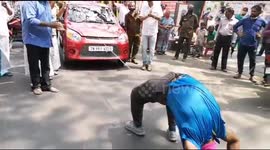 Indian yoga instructor pulls car while in a handstand to support election candidate