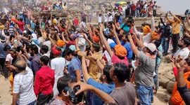 Hindu men play with colourful ashes during the Holi festival in Manikarnika GhatVaranasi
