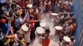 Hindu men play with colourful ashes during the Holi festival in Varanasi Manikarnika Ghat