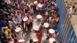 Hindu men play with colourful ashes during the Holi festival in Varanasi Manikarnika Ghat