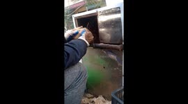 Vietnamese man builds the dried coconut shell peeler machine from the saws blade and an electric motor
