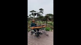Retired music teacher plays multiple instruments simultaneously in south China