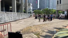 Political activists walking out of the Office of Attorney General after their indictment was postponed in Bangkok, Thailand