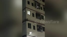 Chinese neighbours catch girl falling from third floor of building with quilt