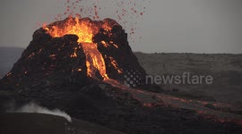 Person in background behind erupting Geldingadalir volcano Iceland 2021