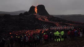 People watching active erupting Geldingadalir volcano, Iceland March 2021