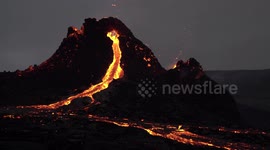 Magma river flows from Geldingadalir eruption volcano cone, Iceland March 2021