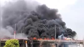 Thick black smoke rises into sky as minibus catches fire on bridge in southern China