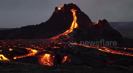 Photographer close to Geldingadalir volcano magma at dusk, Iceland March 2021