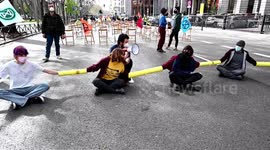 Extinction Rebellion activists stick themselves together and block road in Madrid