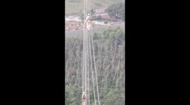 Vietnamese electricians' bravery reaches new heights as they repair power lines dangling above ground