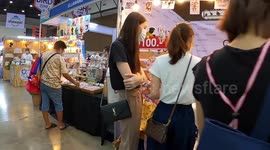 Hold parrots and walk around this colourful pet trade show in Thailand