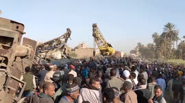 People gather as wreckage of Egypt train crash is cleared