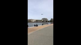 Helicopter over Tidal Basin cherry Blossom season.  View from the Jefferson Memorial with Washington Monument in background