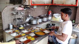 The cook person has preparing for indian special thali for customers at street Hotel in Haridwar Halkipuri