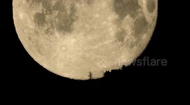 Stunning 4K footage of Worm supermoon setting behind Swiss mountain