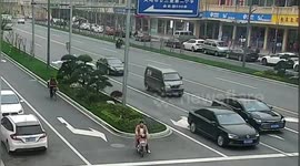 Tyre hits motorbike after falling off truck on Chinese road