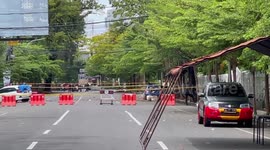 Police officers set up a police line in the area of the explosion