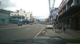 Truck nearly hits motorcycle rider making a sharp u-turn in the Philippines