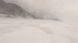 Russian man trudges across world's deepest lake in blustering snowstorm