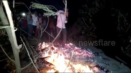 Villagers walk barefoot across burning coal during Holi celebrations in India